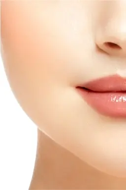 Close-up of lower face showing glossy pink lips and cheek