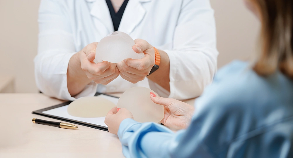 A woman consulting her plastic surgeon on breast implant types