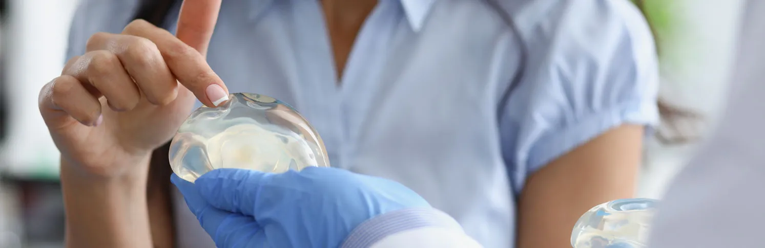 A woman consulting a specialist about breastfeeding concerns after breast augmentation