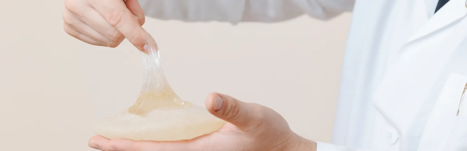 A doctor showing the silicone gel in a silicone breast implant