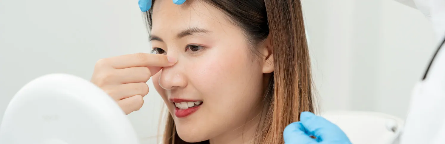 A woman consulting a specialist for her second rhinoplasty surgery