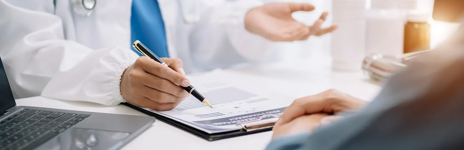 A surgeon discussing droopy eyelid surgery with a patient.